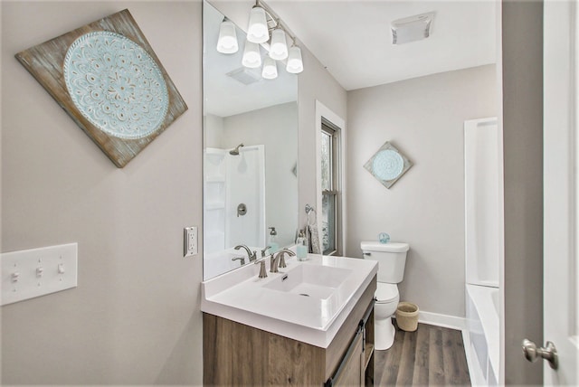 full bathroom featuring wood-type flooring,  shower combination, vanity, and toilet