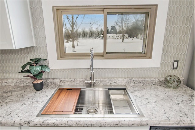 interior details with sink and white cabinets