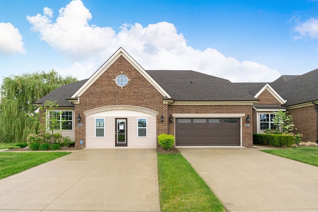 view of front of home with a garage and a front lawn