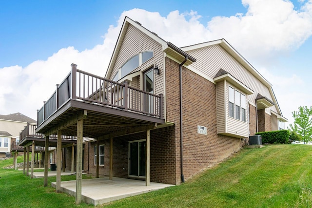 rear view of property featuring a patio area, central AC unit, a lawn, and a deck