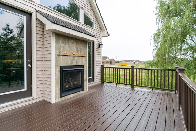 wooden deck featuring a tile fireplace