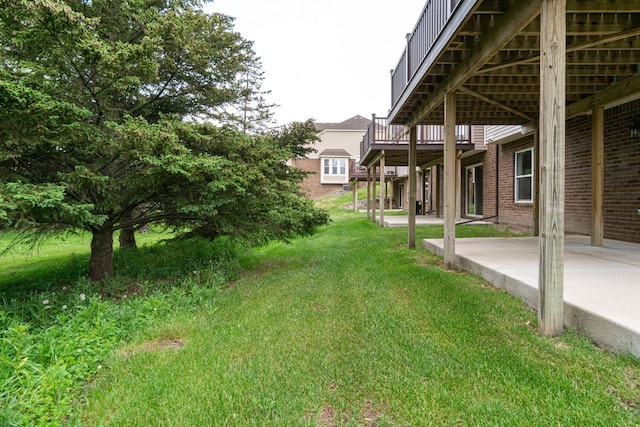 view of yard featuring a patio and a deck