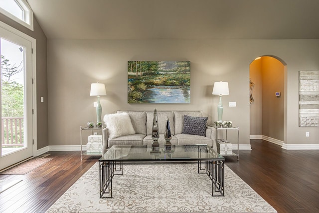 living room featuring dark hardwood / wood-style flooring and vaulted ceiling