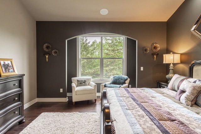 bedroom with dark hardwood / wood-style floors