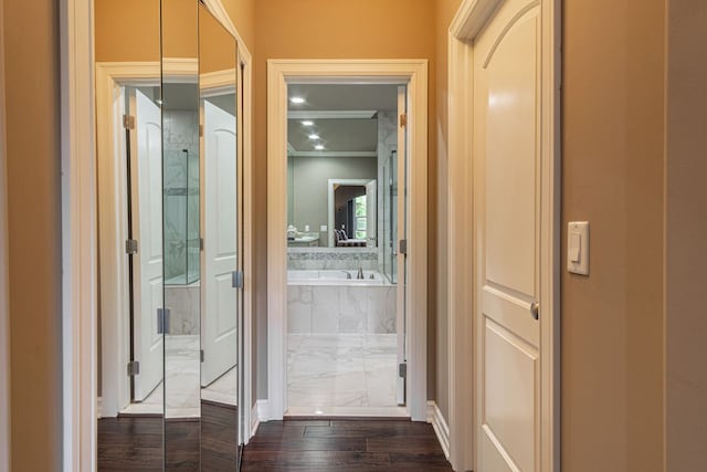 hall with ornamental molding and dark hardwood / wood-style floors