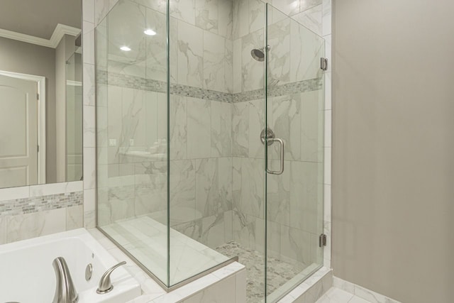 bathroom with shower with separate bathtub and ornamental molding