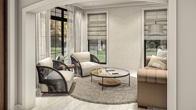 sitting room featuring crown molding, plenty of natural light, and light hardwood / wood-style floors