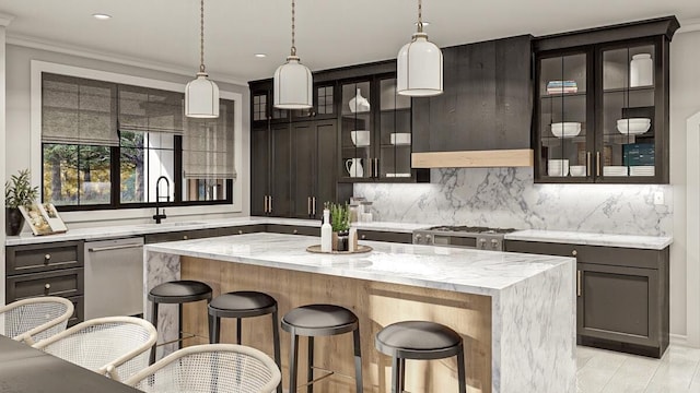 kitchen with a center island, stove, sink, hanging light fixtures, and light stone countertops