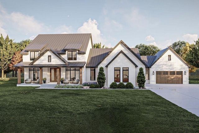 modern farmhouse style home with covered porch, a garage, and a front lawn