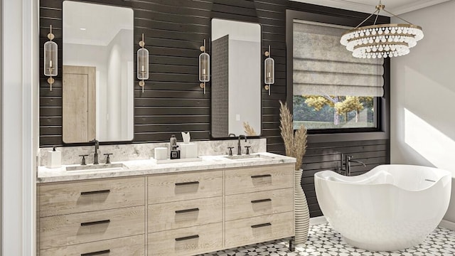 bathroom featuring tile patterned floors, vanity, crown molding, a chandelier, and a bathing tub