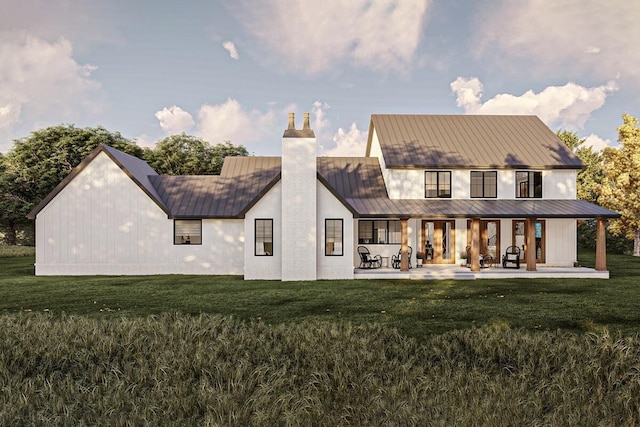 back of house featuring a patio area and a lawn