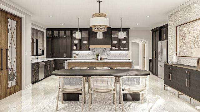 kitchen with appliances with stainless steel finishes, dark brown cabinets, crown molding, a center island, and hanging light fixtures