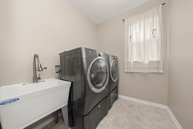 clothes washing area featuring washing machine and dryer and sink