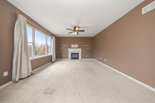 unfurnished living room featuring ceiling fan and light colored carpet