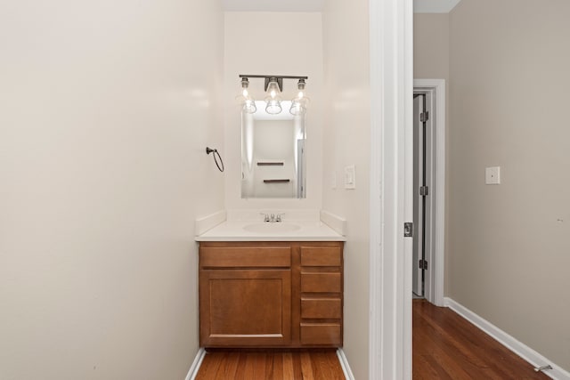 bathroom with hardwood / wood-style floors and vanity