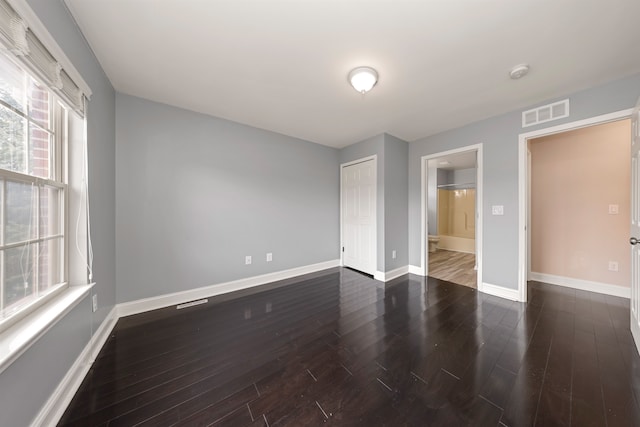 spare room with dark wood-type flooring