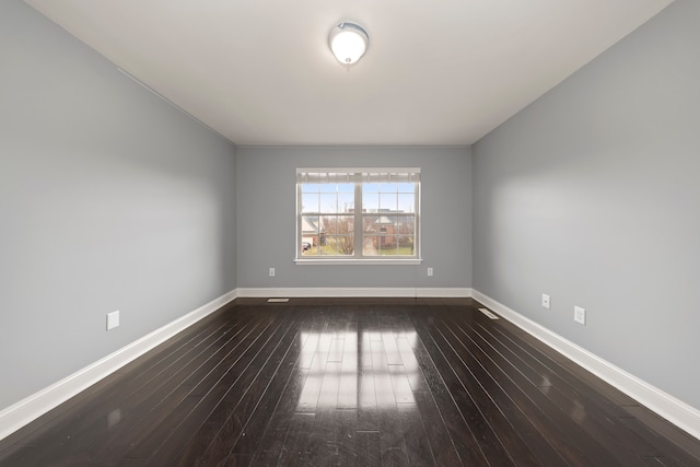 spare room featuring dark wood-type flooring