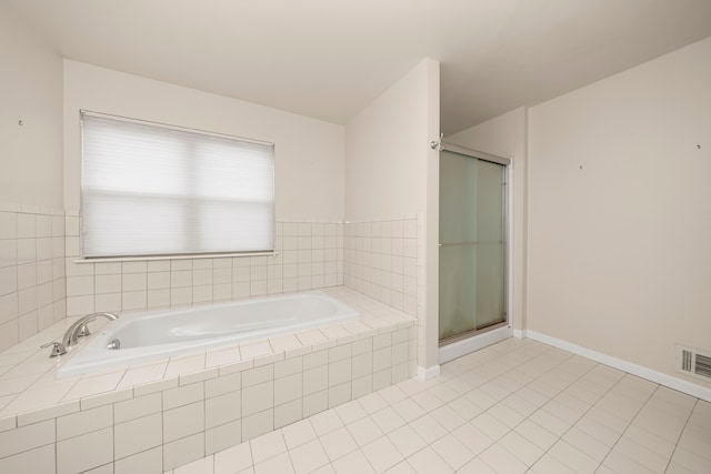 bathroom featuring tile patterned floors and plus walk in shower