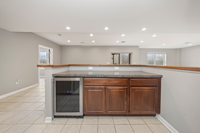 kitchen featuring light tile patterned floors and wine cooler