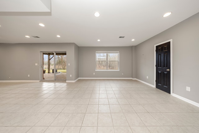 spare room featuring a healthy amount of sunlight and light tile patterned floors