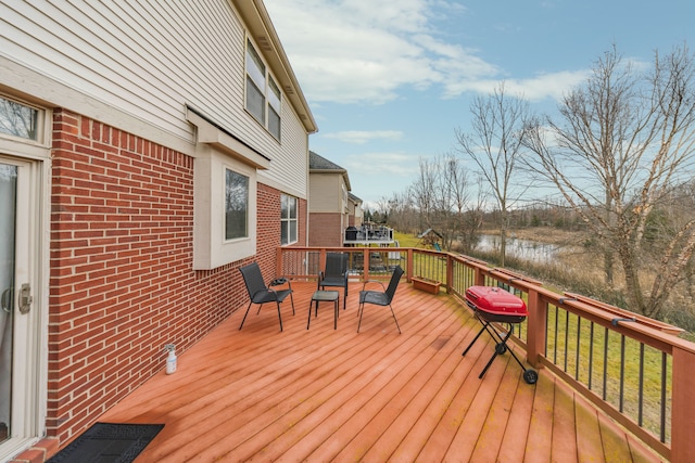 deck featuring a grill and a water view