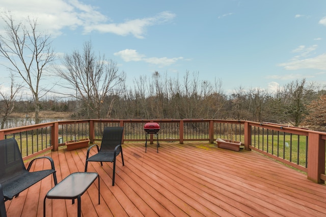 wooden terrace featuring a yard