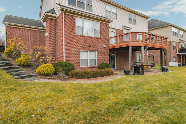 rear view of house with a deck and a lawn