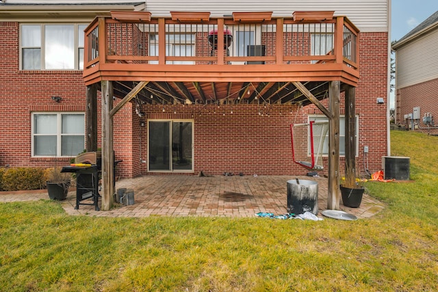 rear view of property featuring a patio area, a yard, central AC unit, and a deck