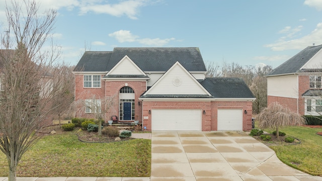 view of front of property with a front yard and a garage