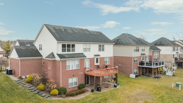 back of property featuring a lawn, cooling unit, and a wooden deck