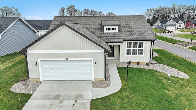 view of front of home with a garage and a front lawn