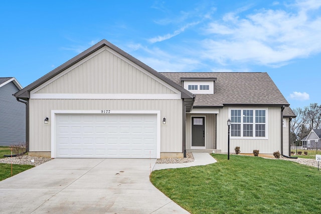 view of front of home with a front yard and a garage