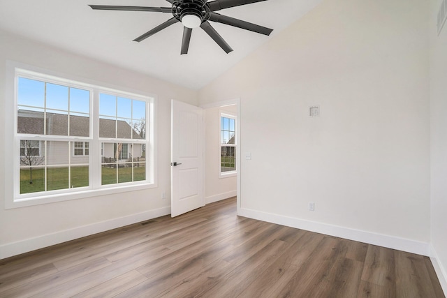 empty room with wood-type flooring, vaulted ceiling, and ceiling fan