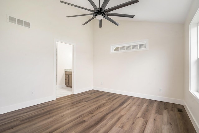 empty room featuring ceiling fan, wood-type flooring, and lofted ceiling