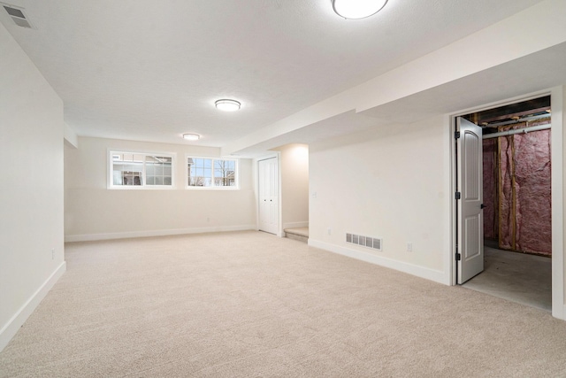 basement with light carpet and a textured ceiling