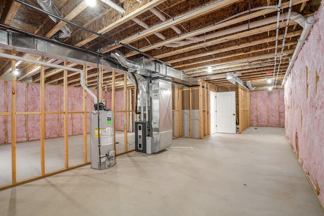 basement featuring gas water heater and heating unit