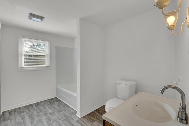 bathroom featuring hardwood / wood-style floors, vanity, and toilet