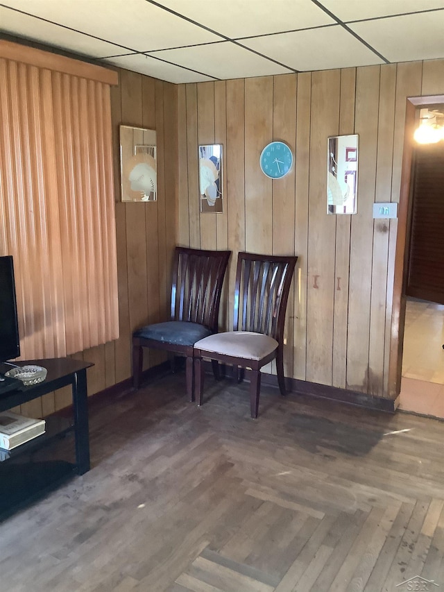 4135 Gallagher St, Saginaw, MI 48601 - sitting room featuring dark parquet flooring, a paneled ceiling, and wooden walls
