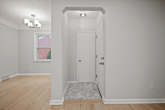 entryway featuring a notable chandelier and light hardwood / wood-style flooring