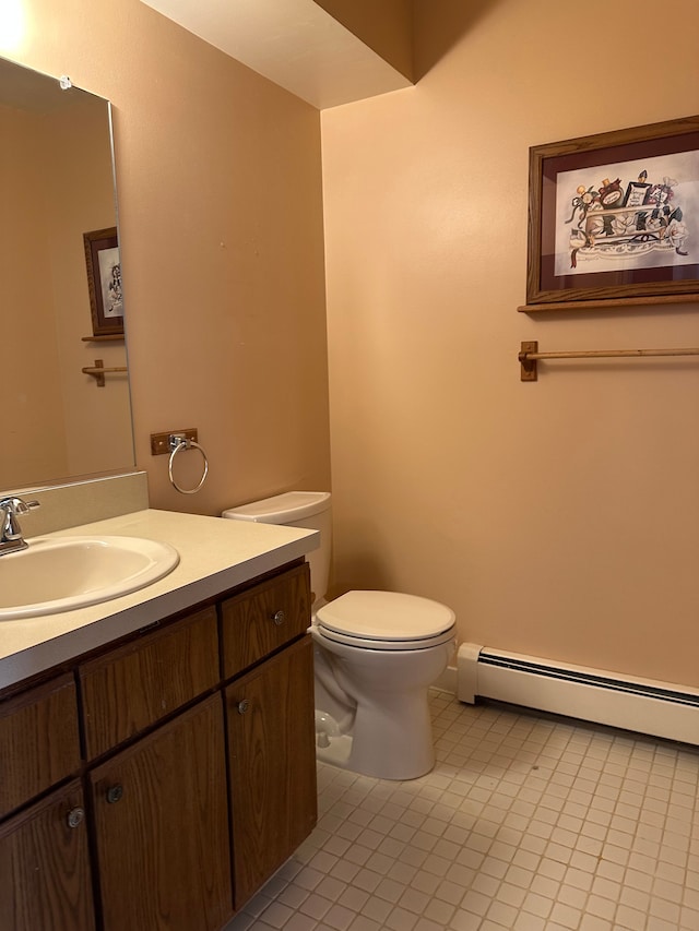 bathroom featuring tile patterned floors, vanity, toilet, and baseboard heating