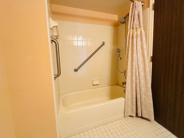 bathroom with tile patterned floors and shower / bath combo with shower curtain