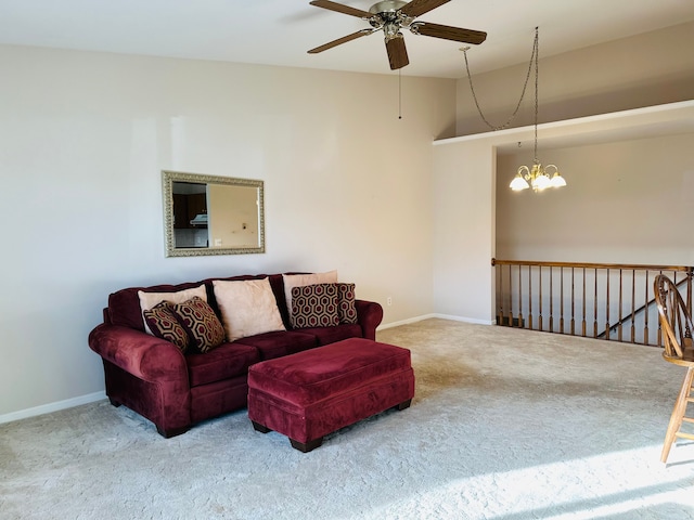 carpeted living room featuring ceiling fan with notable chandelier and lofted ceiling