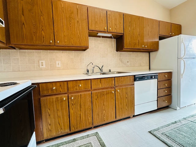 kitchen with white appliances, tasteful backsplash, and sink