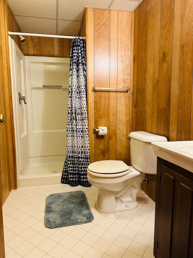 bathroom with a shower with curtain, tile patterned floors, toilet, a paneled ceiling, and vanity