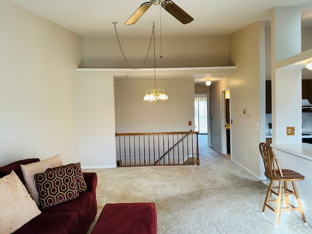 living room with ceiling fan with notable chandelier, a towering ceiling, and carpet floors