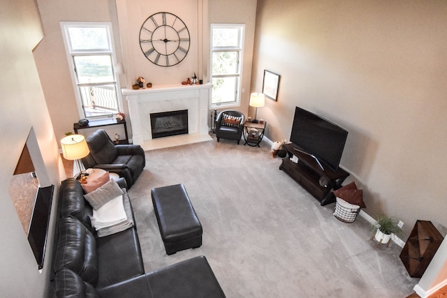 carpeted living room featuring a fireplace