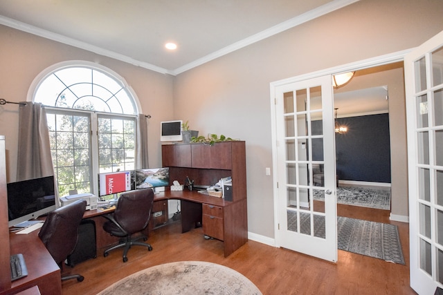 office space with a chandelier, french doors, light hardwood / wood-style flooring, and crown molding