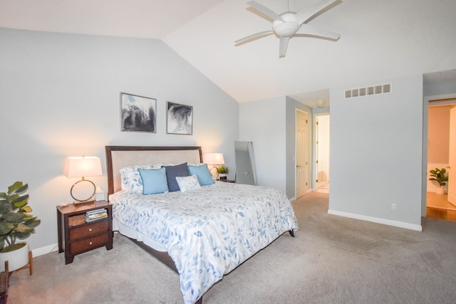 carpeted bedroom with ceiling fan, vaulted ceiling, and ensuite bath