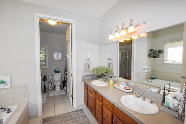 full bathroom with tile patterned floors, vanity, shower with separate bathtub, and toilet