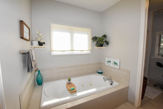 bathroom with tiled bath and tile patterned floors